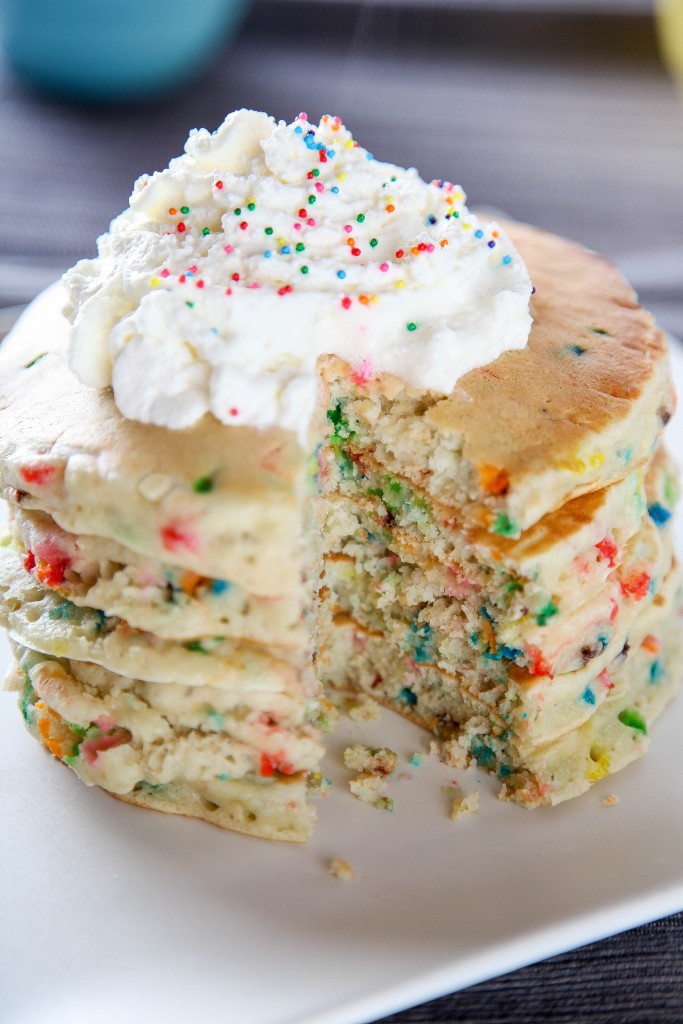 Cake Batter Funfetti Pancakes topped with whipped cream and sprinkles