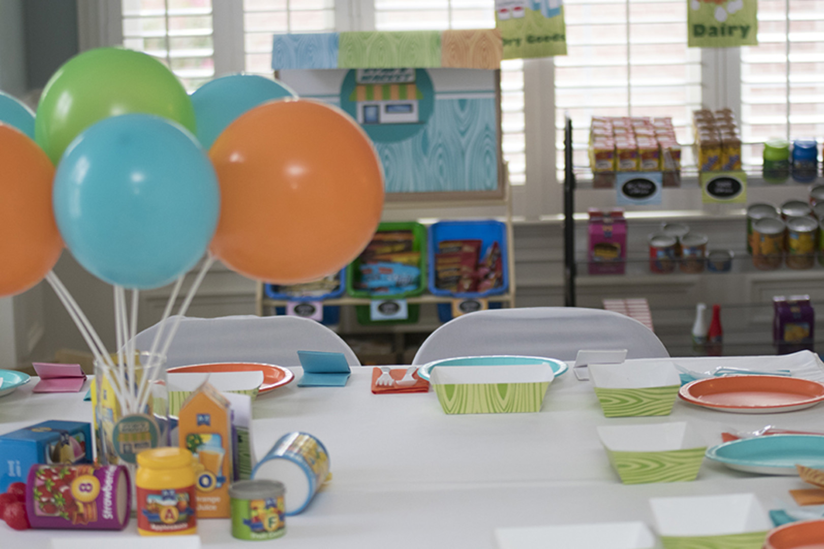 grocery store themed first birthday party table and activities