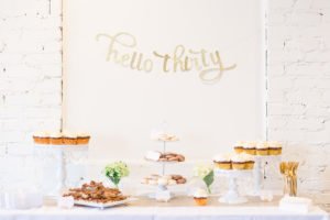 Are you turning 30 or planning a milestone 30th birthday party and need ideas or themes? We have a sweet and classy party for her complete with gold decorations, a photo booth and a dessert table to inspire your event! #30thbirthday #30th #partyideas #birthday