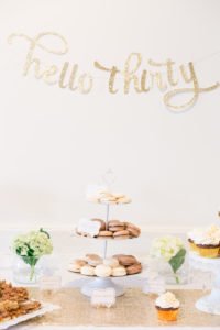 Are you turning 30 or planning a milestone 30th birthday party and need ideas or themes? We have a sweet and classy party for her complete with gold decorations, a photo booth and a dessert table to inspire your event! #30thbirthday #30th #partyideas #birthday