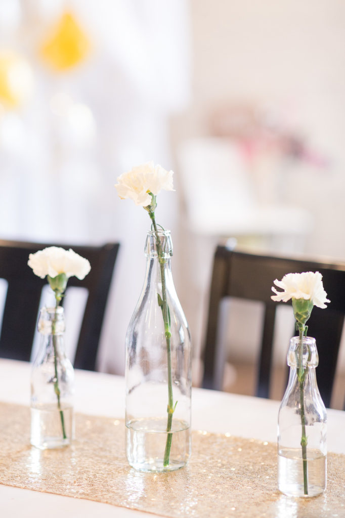 white flowers in glass vases on tabletop