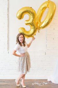 Are you turning 30 or planning a milestone 30th birthday party and need ideas or themes? We have a sweet and classy party for her complete with gold decorations, a photo booth and a dessert table to inspire your event! #30thbirthday #30th #partyideas #birthday