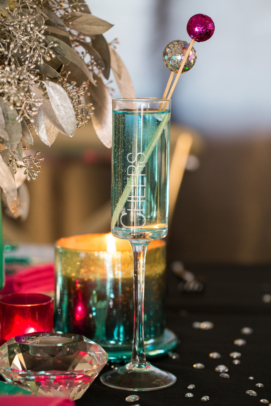 New Year's eve champagne glass with glitter drink stirrers