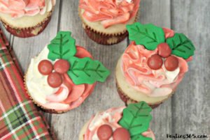 Looking for Christmas Cupcake ideas for the holidays? Our Holly Cupcake Recipe is a fancy dessert that's still easy to make! The cute fondant leaves and M&M berries really stand out on the candy cane inspired frosting. Click for the full recipe! #holidaybaking #holidayrecipes #Christmas