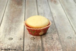 Looking for Christmas Cupcake ideas for the holidays? Our Holly Cupcake Recipe is a fancy dessert that's still easy to make! The cute fondant leaves and M&M berries really stand out on the candy cane inspired frosting. Click for the full recipe! #holidaybaking #holidayrecipes #Christmas