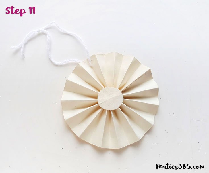 white paper fan ornament with string