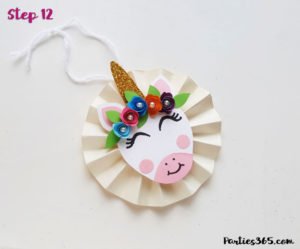This cute DIY paper unicorn ornament for Christmas will look adorable on the tree and is fun for all ages! Our tutorial and printable template will show you how to make the ornaments - let the glitter and creativity run wild! #Christmascraft #unicorns #printable #crafts