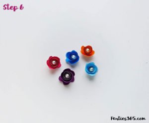 This cute DIY paper unicorn ornament for Christmas will look adorable on the tree and is fun for all ages! Our tutorial and printable template will show you how to make the ornaments - let the glitter and creativity run wild! #Christmascraft #unicorns #printable #crafts