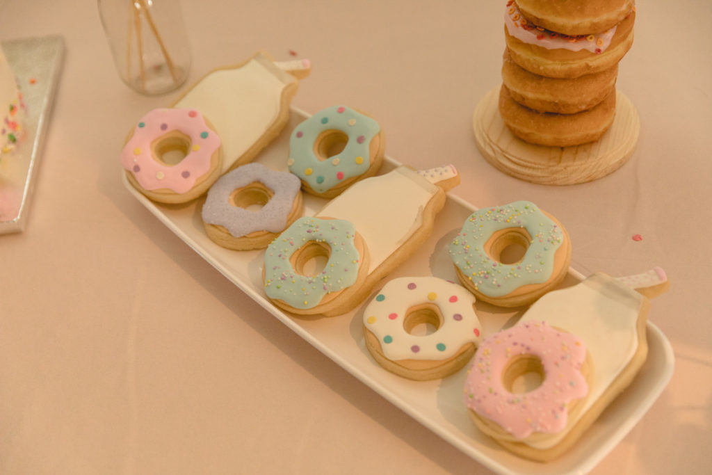 donut sugar cookies on a white tray with glass of milk sugar cookies