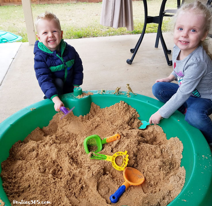 kids doing a dinosaur dig in sandbox
