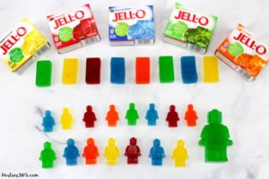 Want a fun treat for your lego themed birthday party? Let us show you how to make colorful Jello Lego blocks and figurines with this easy recipe and mold! #legos #legoparty #legofood #birthday #partyfood