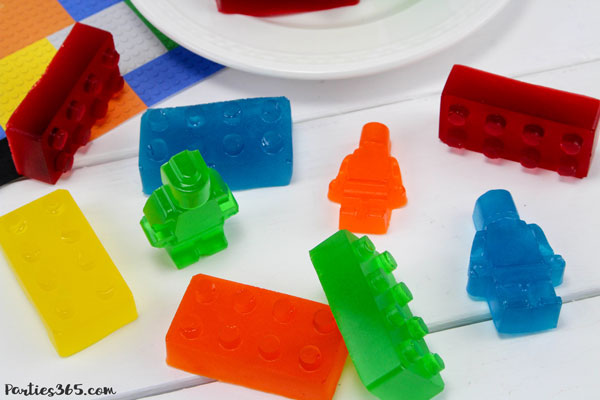 Want a fun treat for your lego themed birthday party? Let us show you how to make colorful Jello Lego blocks and figurines with this easy recipe and mold! #legos #legoparty #legofood #birthday #partyfood 