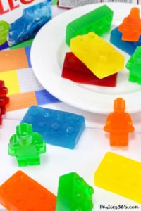 Want a fun treat for your lego themed birthday party? Let us show you how to make colorful Jello Lego blocks and figurines with this easy recipe and mold! #legos #legoparty #legofood #birthday #partyfood