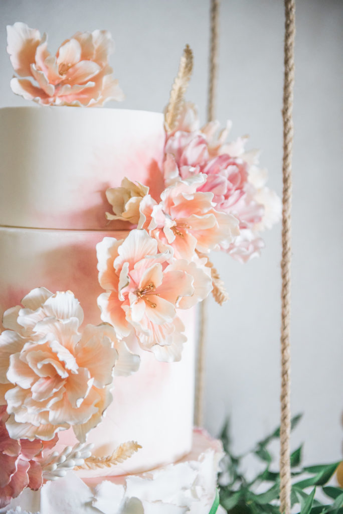 pink flowers made of icing on a party cake