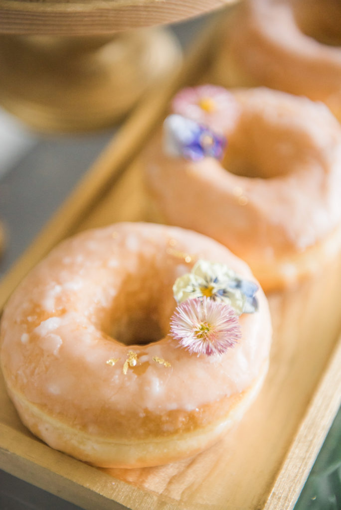 edible flowers on glazed donuts