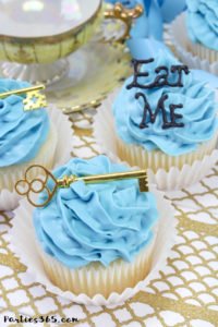 These simple DIY cupcake toppers are perfect for your Alice in Wonderland theme party! The gold key and "Eat Me" decorations are easy ideas to make your party food whimsical and fun for all ages! #AliceinWonderland #cupcakes #TeaPartyIdeas