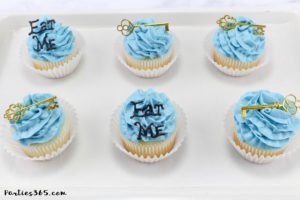 These simple DIY cupcake toppers are perfect for your Alice in Wonderland theme party! The gold key and "Eat Me" decorations are easy ideas to make your party food whimsical and fun for all ages! #AliceinWonderland #cupcakes #TeaPartyIdeas