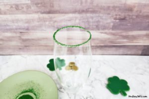 This festive St. Patrick's Day champagne cocktail is a fun and easy drink idea for your party! The simple recipe with sparkling wine, isn't green, but the gold under the rainbow will delight any St. Pattys leprechaun! #stpatricksday #champagne #cocktailrecipe #rainbow