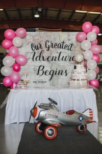 A travel themed baby shower is a perfect idea as the adventure into parenthood begins! Get ideas from vintage maps to custom invitations, favors, decorations and even creative food in this beautiful baby shower held in an airplane hanger! #babyshower #travel #adventuretheme #partyideas