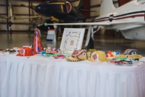A travel themed baby shower is a perfect idea as the adventure into parenthood begins! Get ideas from vintage maps to custom invitations, favors, decorations and even creative food in this beautiful baby shower held in an airplane hanger! #babyshower #travel #adventuretheme #partyideas