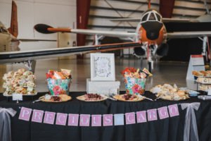 A travel themed baby shower is a perfect idea as the adventure into parenthood begins! Get ideas from vintage maps to custom invitations, favors, decorations and even creative food in this beautiful baby shower held in an airplane hanger! #babyshower #travel #adventuretheme #partyideas