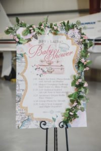 A travel themed baby shower is a perfect idea as the adventure into parenthood begins! Get ideas from vintage maps to custom invitations, favors, decorations and even creative food in this beautiful baby shower held in an airplane hanger! #babyshower #travel #adventuretheme #partyideas