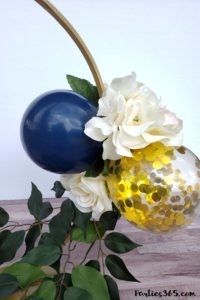 This unique DIY centerpiece, made from an Embroidery Hoop, flowers and mini balloons, is perfect for a party, birthday, wedding, graduation or anniversary! This simple crafts project tutorial will show you how to create beautiful decor for your big event! #centerpiece #embroideryhoop #partydecor #partyideas