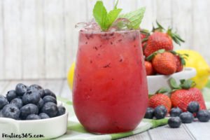 This Bourbon Berry Lemonade cocktail is an easy spring drink that will please a crowd! Get the simple cocktail recipe, made with fresh strawberries and blueberries for your next summer party! #bourbon #cocktail #drinkrecipe #springparty #summer