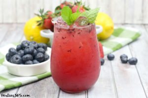 This Bourbon Berry Lemonade cocktail is an easy spring drink that will please a crowd! Get the simple cocktail recipe, made with fresh strawberries and blueberries for your next summer party! #bourbon #cocktail #drinkrecipe #springparty #summer