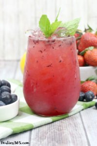 This Bourbon Berry Lemonade cocktail is an easy spring drink that will please a crowd! Get the simple cocktail recipe, made with fresh strawberries and blueberries for your next summer party! #bourbon #cocktail #drinkrecipe #springparty #summer