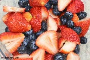 This Bourbon Berry Lemonade cocktail is an easy spring drink that will please a crowd! Get the simple cocktail recipe, made with fresh strawberries and blueberries for your next summer party! #bourbon #cocktail #drinkrecipe #springparty #summer