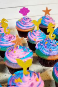 Want an easy idea for a DIY Mermaid Cupcake? This simple Under the Sea theme birthday cupcake is inspired by mermaid magic! We'll show you how to make them and give you ideas for cute toppers! #mermaidcupcake #mermaidparty #underthesea #cupcakes #partyideas