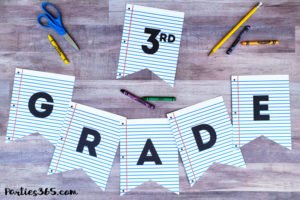 Celebrate Back to School with a notebook paper inspired printable party banner! This free downloadable DIY School Themed Party Banner is the perfect idea for parties, first day pictures or just to add a little fun to the end of summer. #backtoschool #partyprintable #printable #firstdayofschool