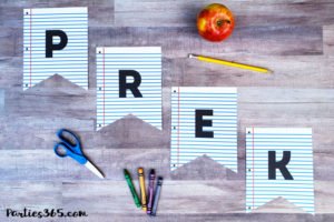 Celebrate Back to School with a notebook paper inspired printable party banner! This free downloadable DIY School Themed Party Banner is the perfect idea for parties, first day pictures or just to add a little fun to the end of summer. #backtoschool #partyprintable #printable #firstdayofschool