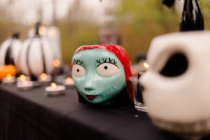 This Jack and Sally, Nightmare Before Christmas inspired Halloween Tablescape is full of decoration ideas for your spooky party or event! With Halloween table settings, centerpieces and display ideas, you'll love recreating this unique table for your guests! #JackandSally #NightmareBeforeChristmas #halloween #tablescape