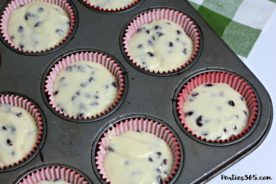 chocolate chip cupcake batter poured into baking cups in pan