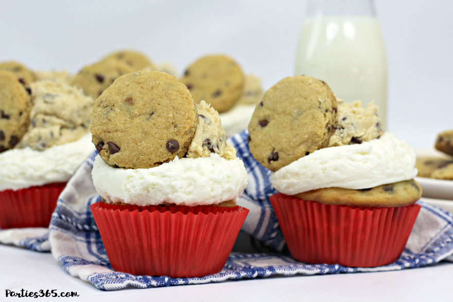 chocolate chip cupcake in red wrapper topped with cookie dough frosting and chocolate chip cookie with a glass of milk