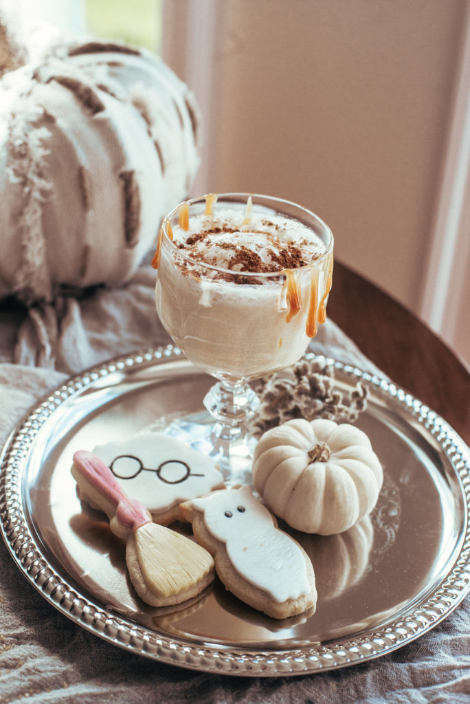 harry potter butterbeer cocktail with sugar cookies and white pumpkins