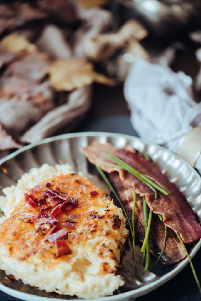 mashed cauliflower with bacon on silver plate at dinner party