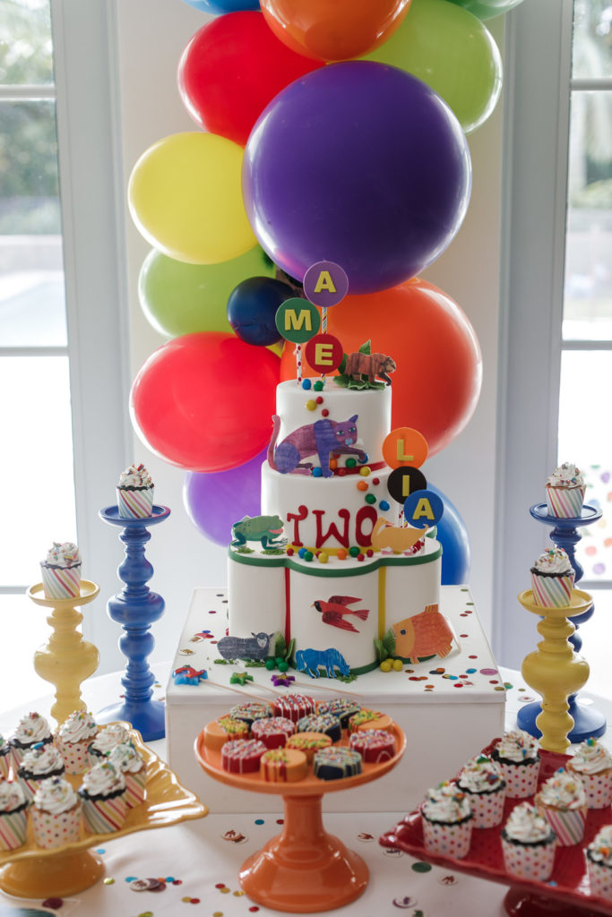 brown bear birthday cake with balloons on dessert table