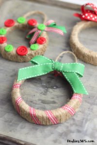 This easy DIY Christmas Mason Jar Lid Wreath craft idea is the perfect ornament for kids to make! It's perfect for teachers, for the tree, for gifts or just as a fun winter project! Instructions and supplies are right here... #christmasornament #christmascraft #christmasDIY #masonjar #masonjarlid