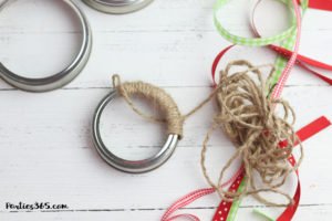 This easy DIY Christmas Mason Jar Lid Wreath craft idea is the perfect ornament for kids to make! It's perfect for teachers, for the tree, for gifts or just as a fun winter project! Instructions and supplies are right here... #christmasornament #christmascraft #christmasDIY #masonjar #masonjarlid