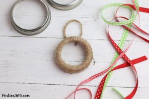 This easy DIY Christmas Mason Jar Lid Wreath craft idea is the perfect ornament for kids to make! It's perfect for teachers, for the tree, for gifts or just as a fun winter project! Instructions and supplies are right here... #christmasornament #christmascraft #christmasDIY #masonjar #masonjarlid