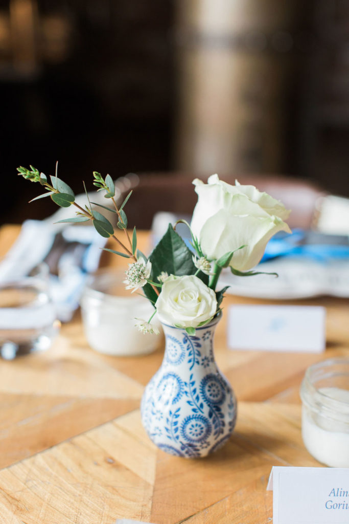 blue and white french inspired vase with white roses