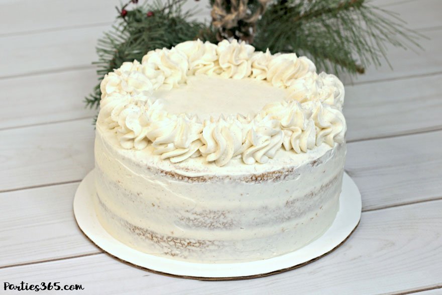 frosted eggnog cake for Christmas on white tray
