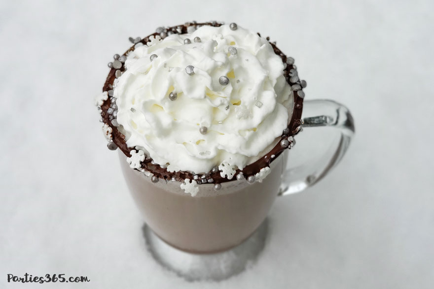 boozy bourbon hot chocolate topped with whipped cream and snowflake sprinkles
