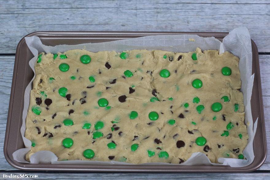 This chewy and delicious St. Patrick's Day Cookie Bar recipe is perfect for a festive dessert! Add chocolate chips and green M&Ms for an easy sheet pan cookie winner!