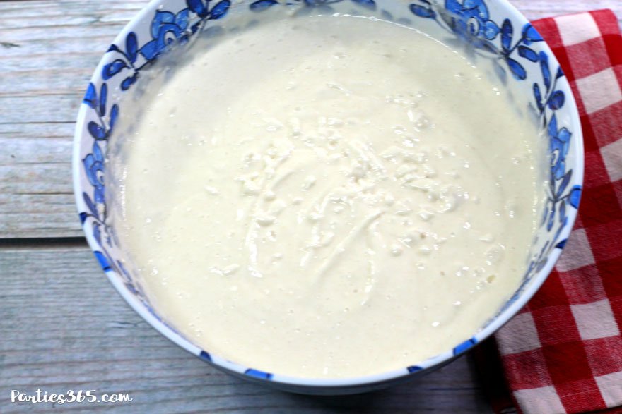 vanilla cake batter in a blue and white bowl