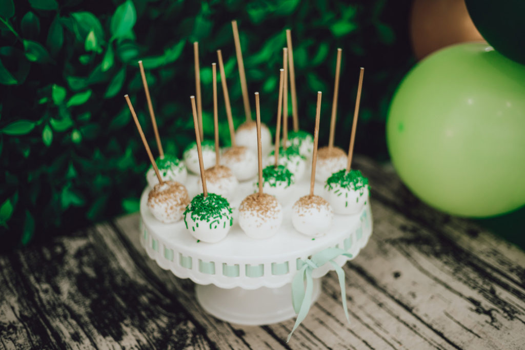 green white and gold cake pops on cake stand