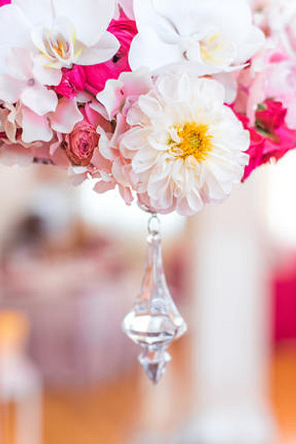 crystal hanging from pink and white floral arrangement at baby shower